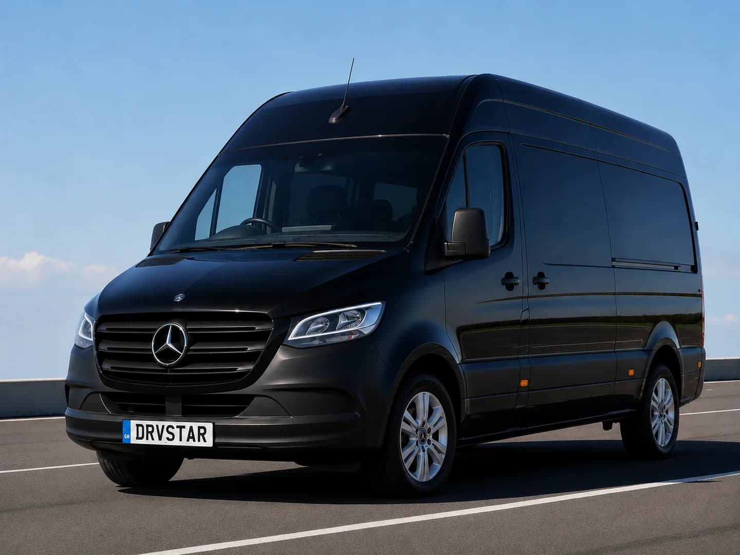 A black executive coach and Mercedes-Benz Sprinter minibus on the forecourt of a British country estate at golden hour - view 3