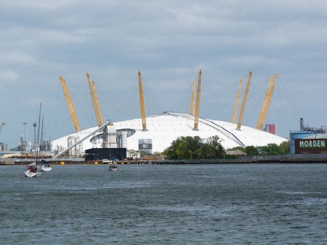 The O2 arena in Greenwich, its white domed roof and yellow support masts seen across the River Thames