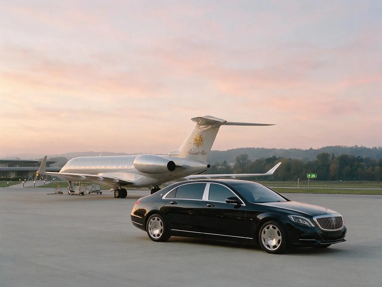 Black luxury car with tinted windows waiting beside a private jet at a quiet terminal