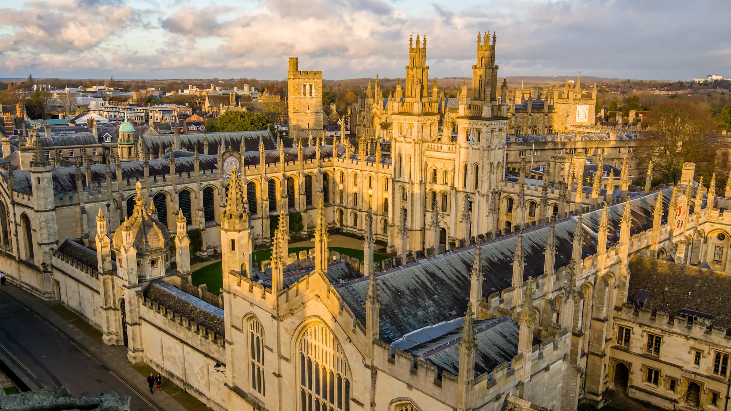 The spires and college rooftops of Oxford in golden evening light
