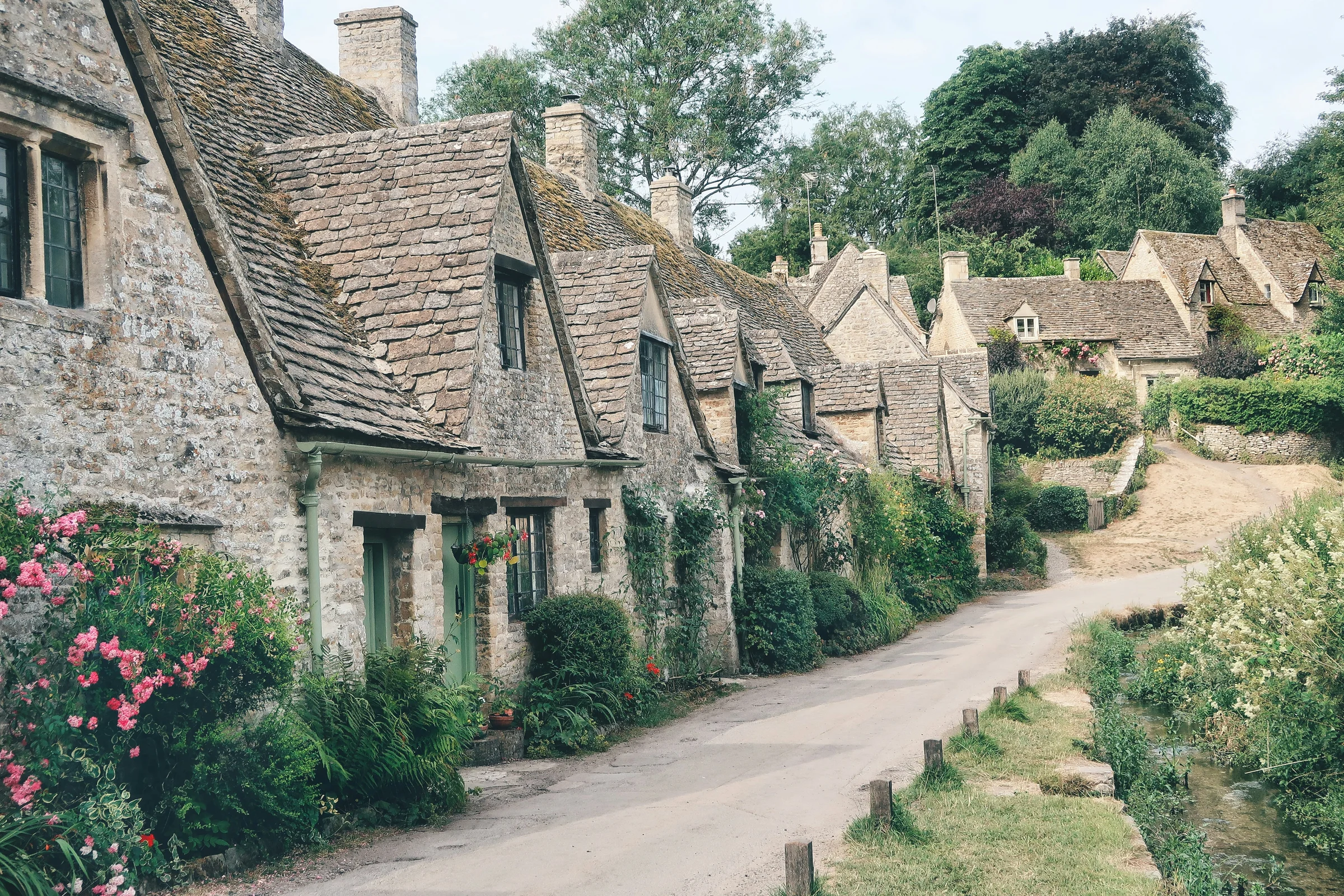 Arlington Row in Bibury, the weavers' cottages of Cotswold stone along a quiet lane beside the River Coln