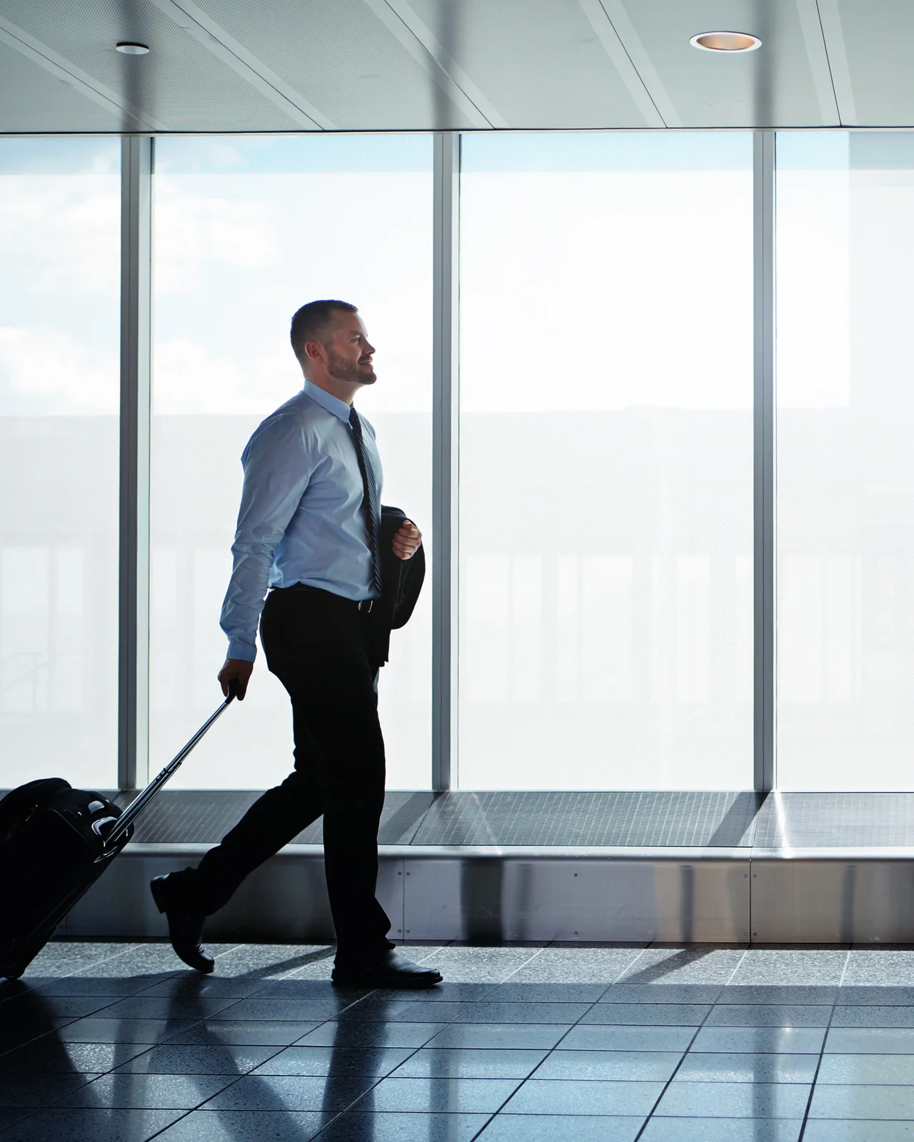 Traveller with a suitcase arriving at the airport terminal
