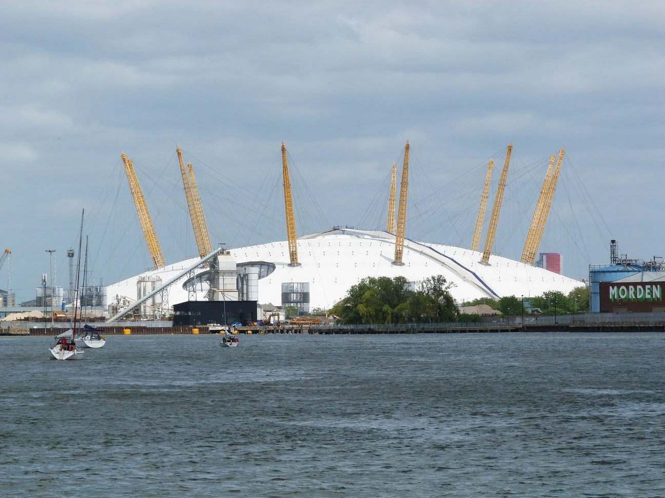 The O2 arena in Greenwich, its white domed roof and yellow support masts seen across the River Thames