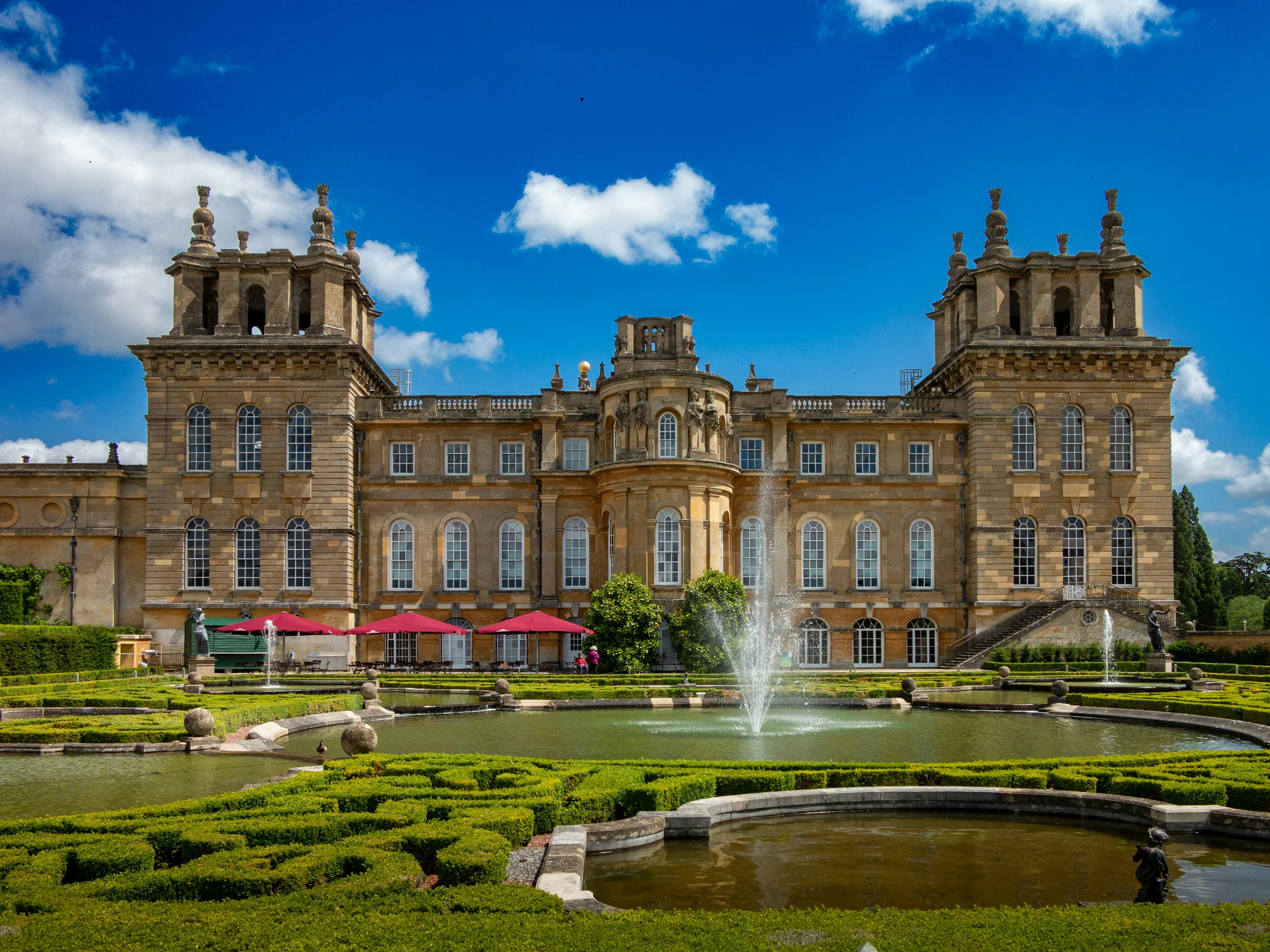 Blenheim Palace from the Water Terraces, its fountain playing in front of the east front