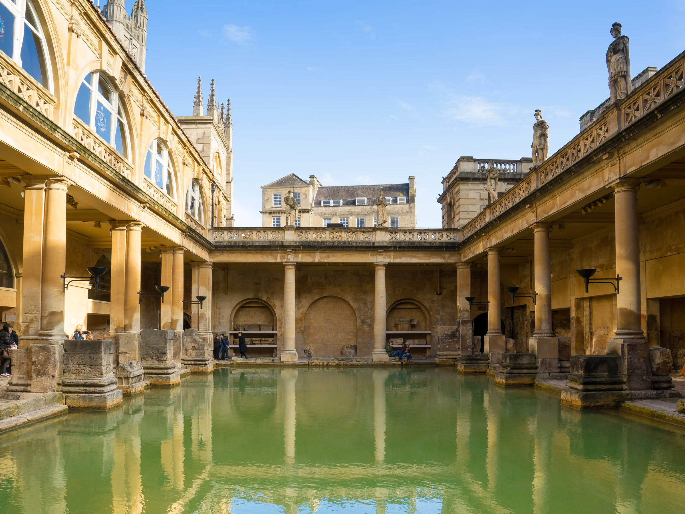 The Great Bath at the Roman Baths, its terrace of statues and Georgian buildings behind