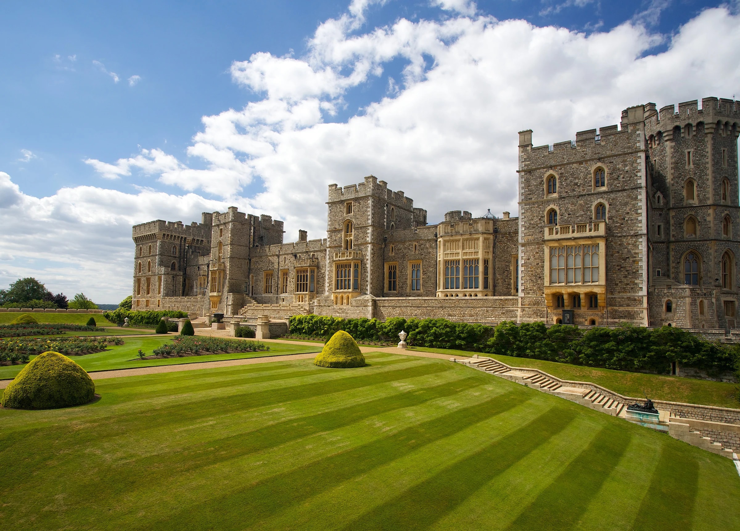 The East Terrace of Windsor Castle seen across its striped lawn under a summer sky